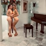 two AR pornstars next to a piano in bikinis